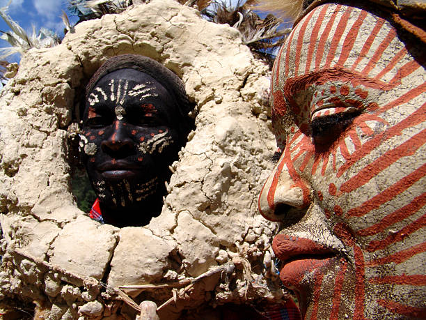 Nyahururu, Kenya: The Kikuyu man is wearing a witch doctor attire and with him, a painted face kikuyu woman at Nyahururu. Kikuyu couple wearing traditional ornaments at Thompson Falls Lodge, Kenya. This couple are always to be found near the falls posing for tourists and earning their money.